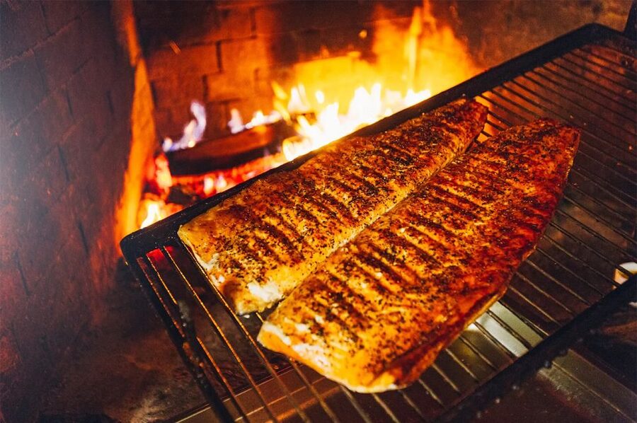 Lapland: Ice Fishing, Floating & BBQ Snow Adventure - The BBQ break: grilled salmon, Lappish bread, and real warmth