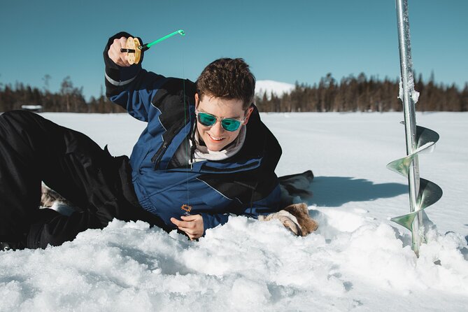 Lappish Lunch Break -Snowmobiling, ice fishing and tasty food - Ice fishing at a secret hole: learn first, fish second