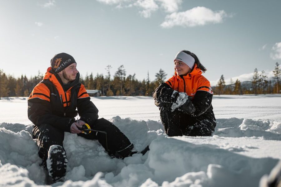 Ylläs: Snowmobile Adventure with Ice Fishing - Ice Fishing on a Frozen Lake: Learning First, Then Trying Your Luck